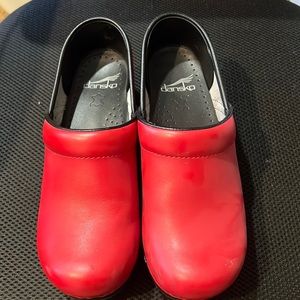 Slightly worn Dansko. Red with minor scuff as shown.
